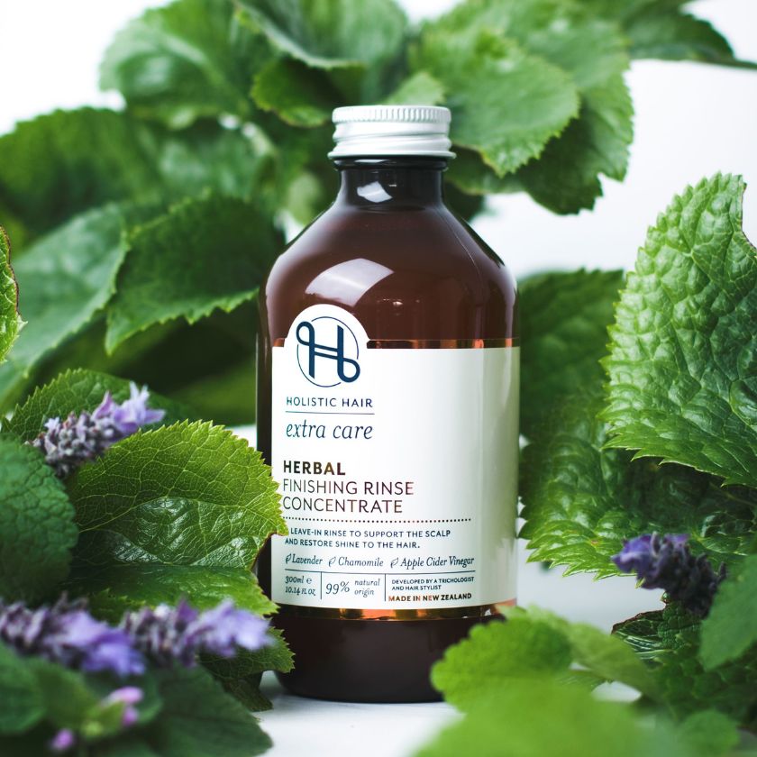 Herbal Finishing Rinse Concentrate on a botanical background.