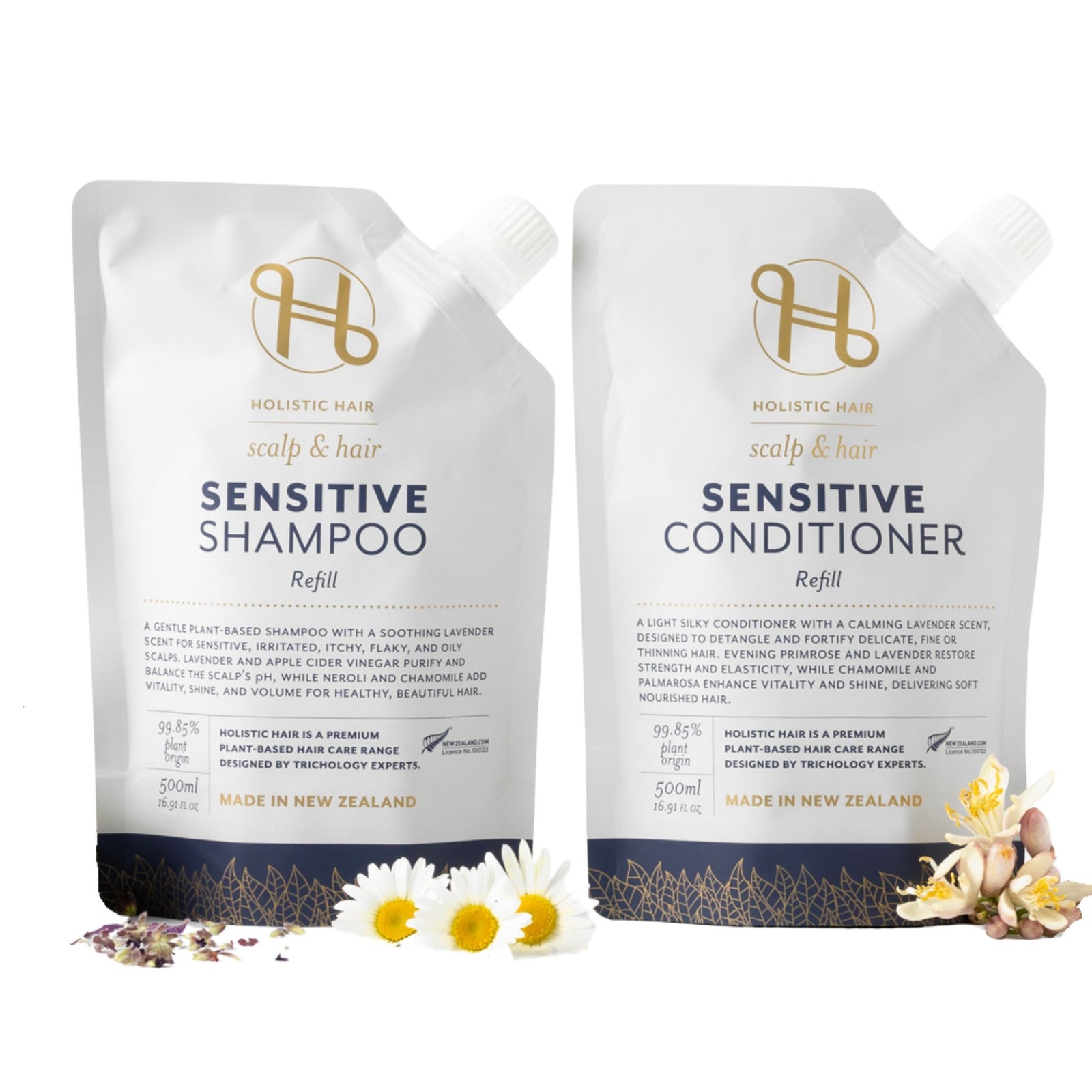 Two Holistic Hair Sensitive Shampoo and Conditioner refill packs on a white background with flowers.